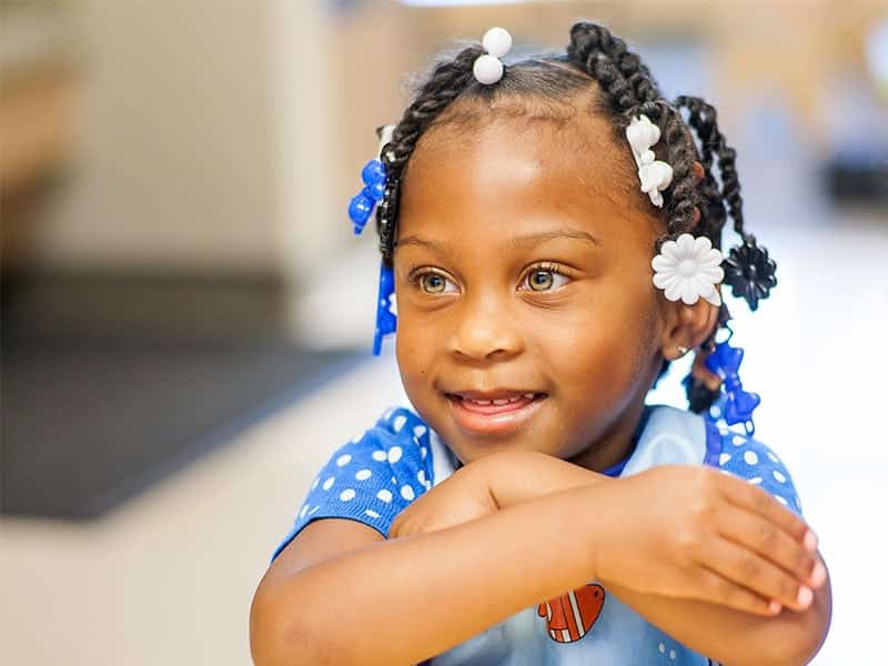 Young child sitting at desk in classroom