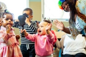 Children laughing and singing with educators at Educare Chicago