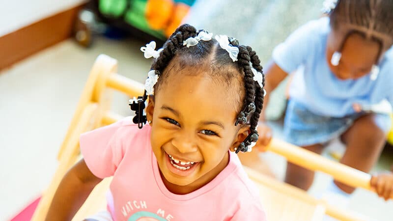 Young child in classroom laughing