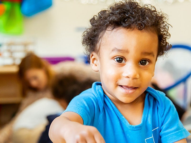 Young child playing in classroom